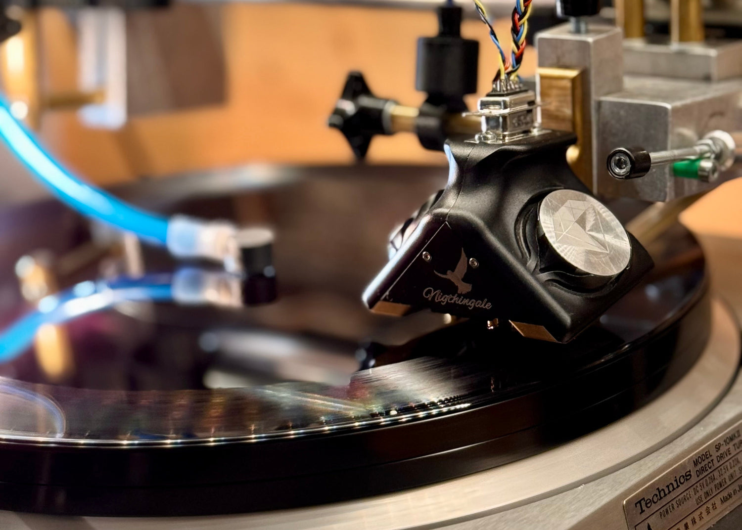 Close-up of a turntable cutterhead on a record with a blurred background